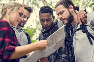 Diverse group of hikers reading a map