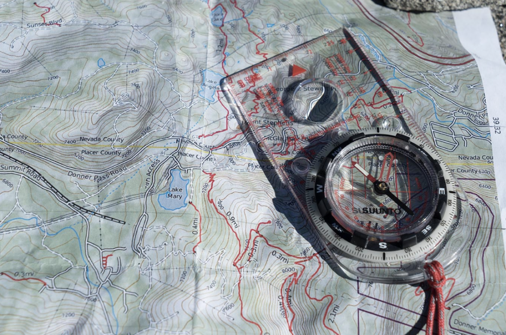 a compass sits on top a paper map
